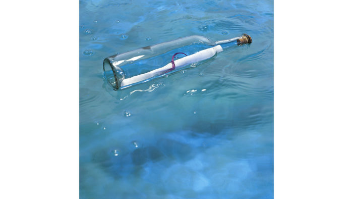 A bottle in the water with a message inside.