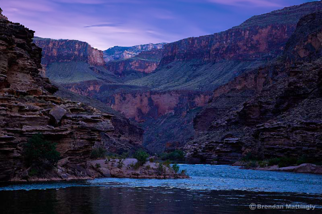 A river flowing through the middle of a mountain range.