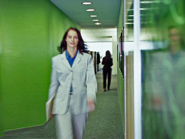 A woman walking down a hallway.